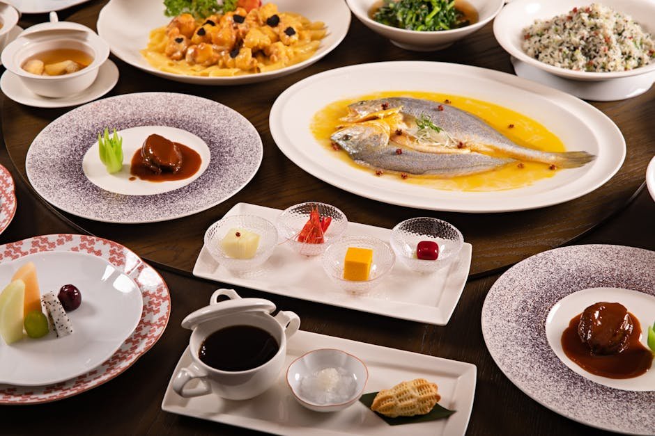 An elegant display of Chinese banquet dishes featuring fish, desserts, and vibrant accompaniments.